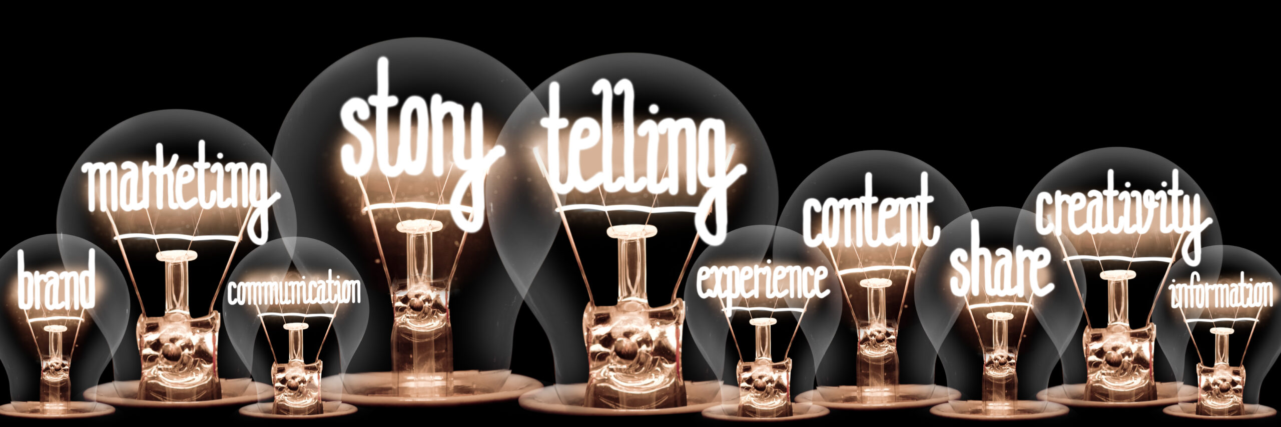 Neon words within lightbulbs that read 'storytelling' 'creativity' 'experience' 'marketing'